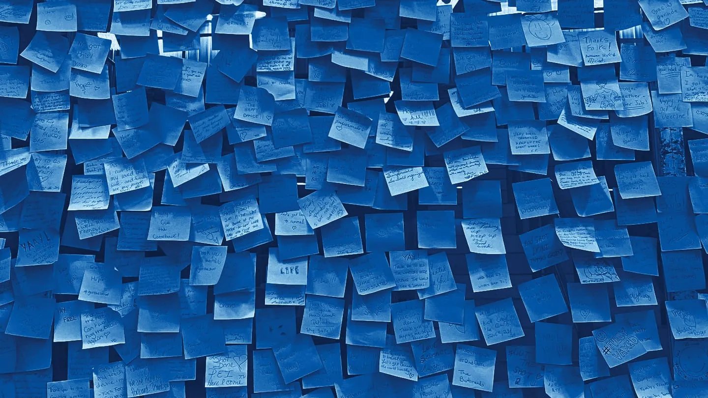 A wall covered in sticky notes from a research workshop