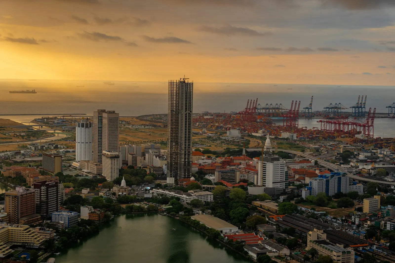 Colombo's skyline and harbour cranes at golden hour, seen from above Beira Lake